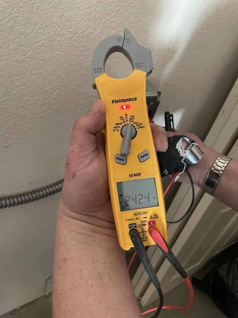 Voltage testing with clamp meter during Ceiling Fan Installation in Charlotte